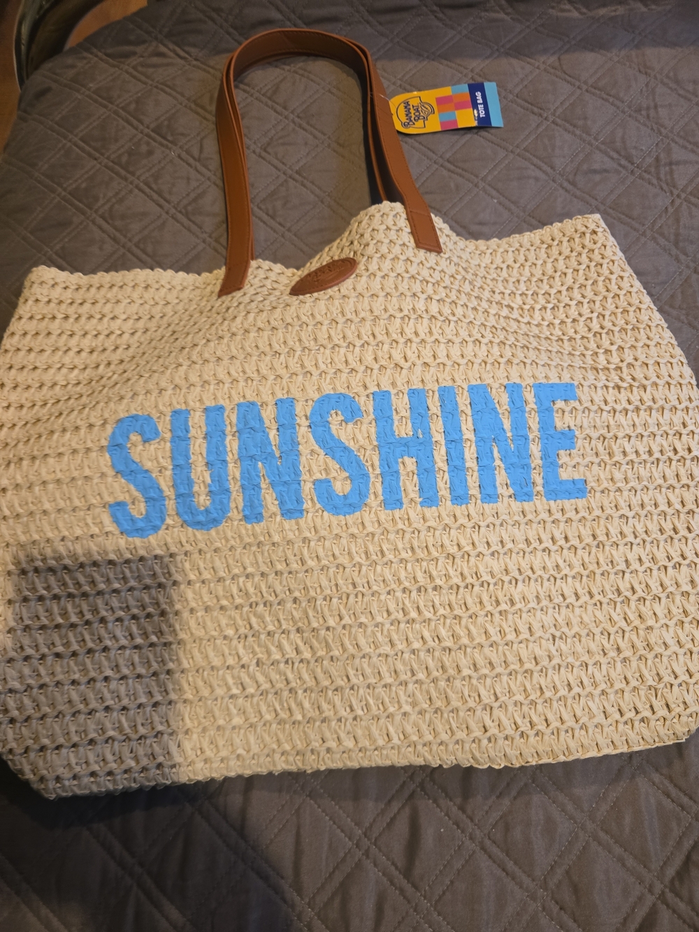 Sunshine Straw Tote Bag with Blue Text and Brown Handles